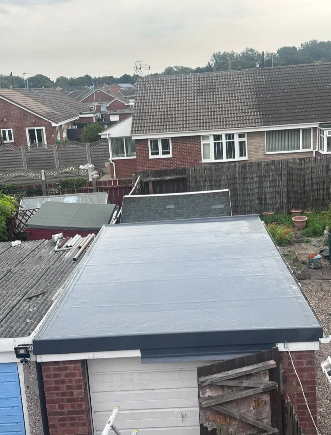 Finished flat garage roof with a smooth dark waterproof covering.