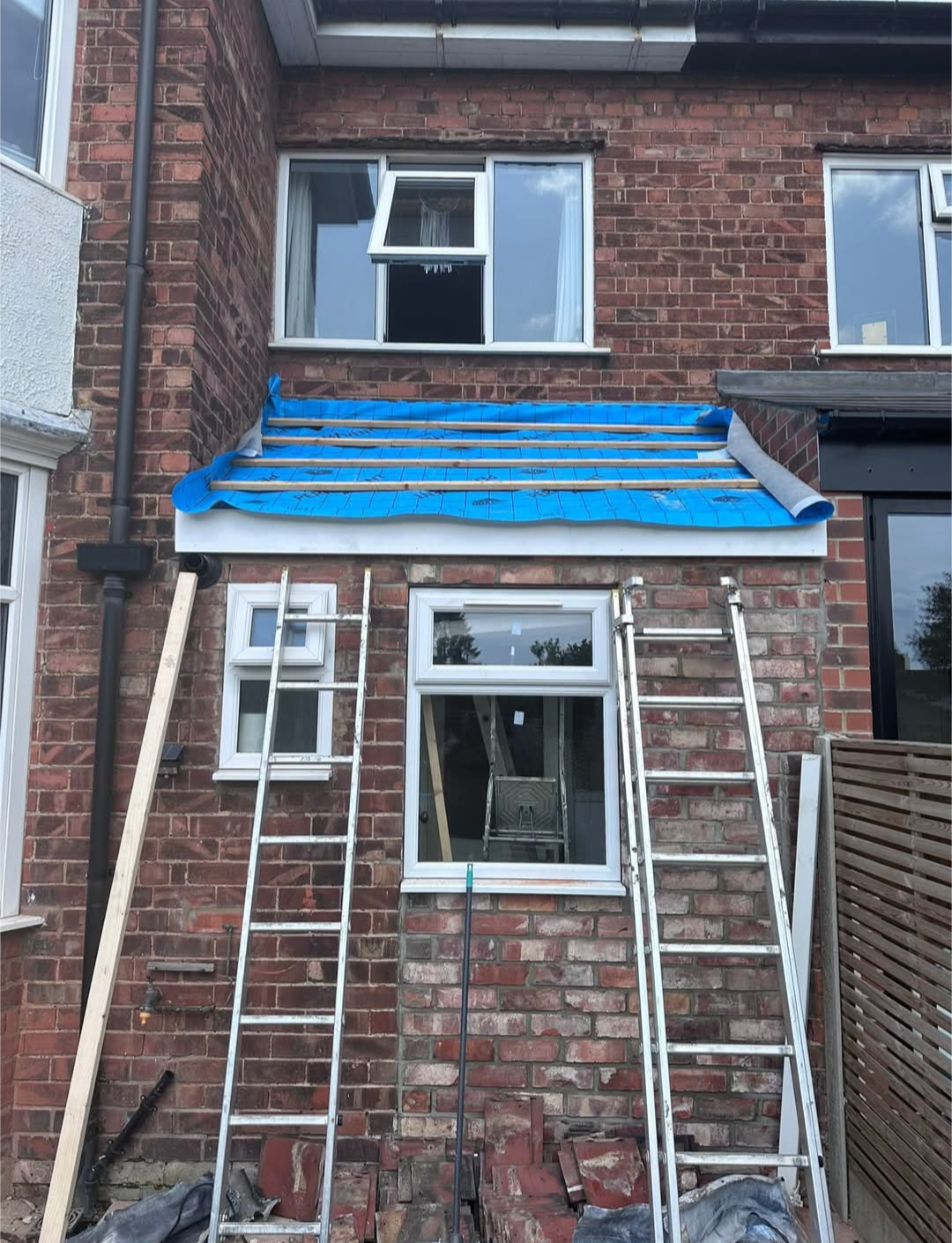 Bay window roof prepared with blue membrane and battens before tiles are installed.